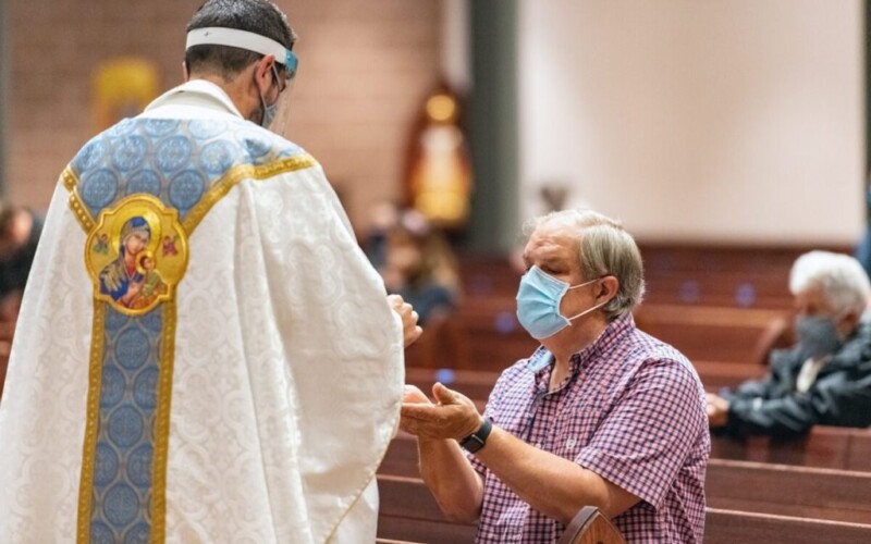 Mark Galli kneels during Mass at St. Michael Catholic Church on Sept. 8, 2020, in Wheaton, Illinois. RNS photo by Tom Killoran