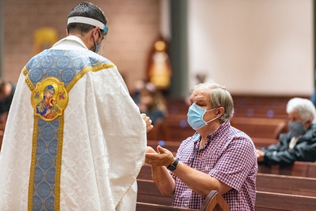 Mark Galli kneels during Mass at St. Michael Catholic Church on Sept. 8, 2020, in Wheaton, Illinois. RNS photo by Tom Killoran