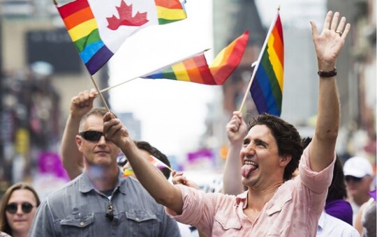 Prime Minister Justin Trudeau waves a flag as he takes part in the annual Pride Parade in Toronto on Sunday, July 3, 2016. PHOTO BY NATHAN DENETTE /THE CANADIAN PRESS