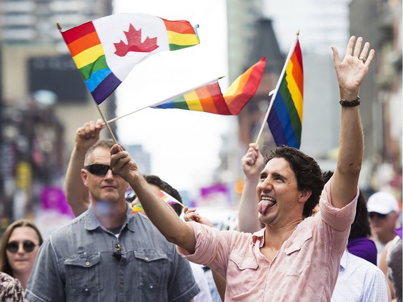 Prime Minister Justin Trudeau waves a flag as he takes part in the annual Pride Parade in Toronto on Sunday, July 3, 2016. PHOTO BY NATHAN DENETTE /THE CANADIAN PRESS