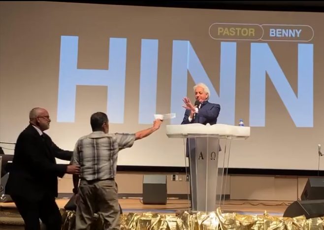 BENNY HINN, WHO WE THOUGHT SPARKED AN END TO THE SATANICALLY-DRIVEN PROSPERITY GOSPEL, FOR SOME STRANGE REASON WAS PRESENTED WITH A LAWSUIT WHILE HE WAS PREACHING A SERMON RECENTLY