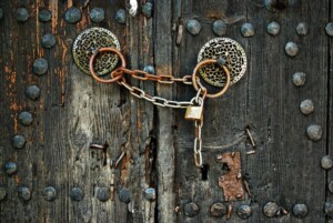 padlock and chain on an old wooden gate